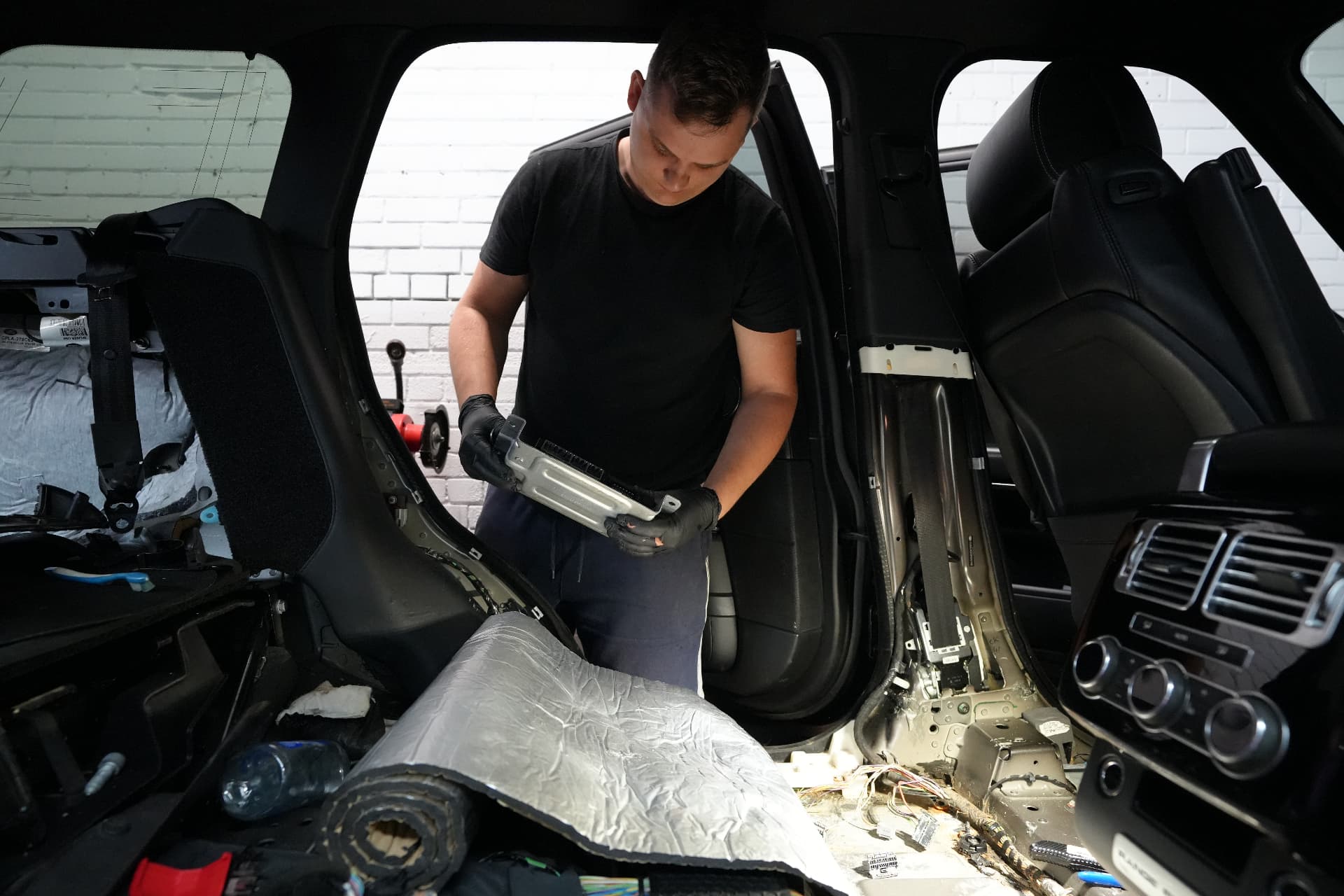 Mechanic holding a car control module